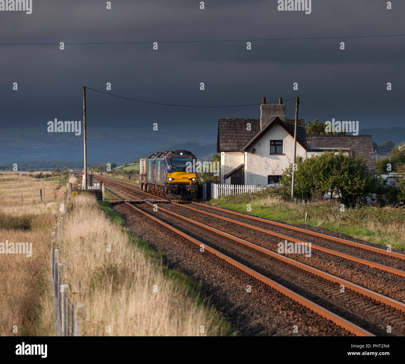 2 Direct Rail Services class 88 bi mode electric & Diesel locomotives on the Cumbrian coast line with a  Sellafield - Crewe nuclear flask train Stock Photo