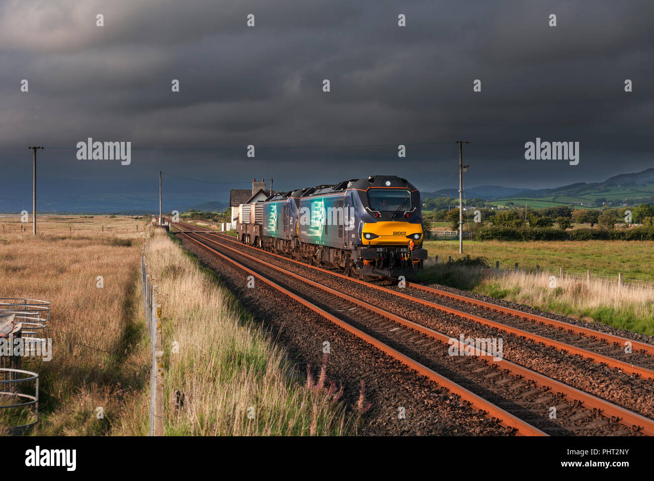 2 Direct Rail Services class 88 bi mode electric & Diesel locomotives on the Cumbrian coast line with a  Sellafield - Crewe nuclear flask train Stock Photo