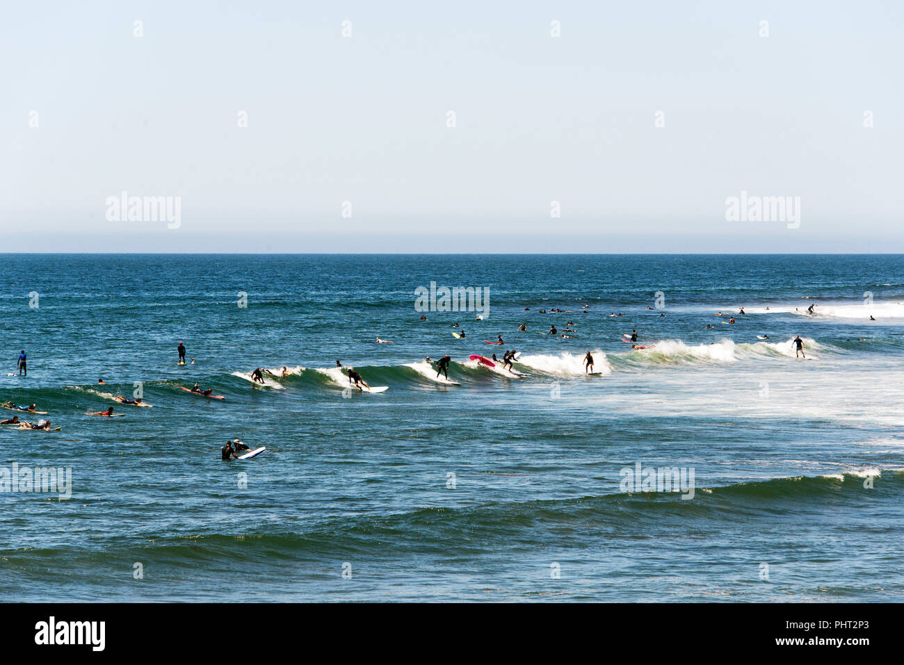 Surfers riding the waves in Malibu beach in summer time Stock Photo