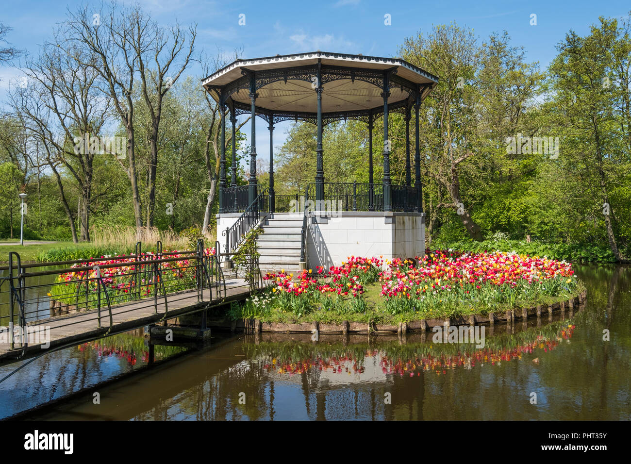bridge with beautiful  park kiosk and tulips in Vondelpark in Amsterdam, Netherlands Stock Photo
