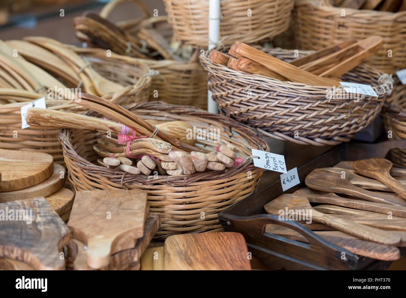 a selection of olive wood handmade items including spoons and tongs in