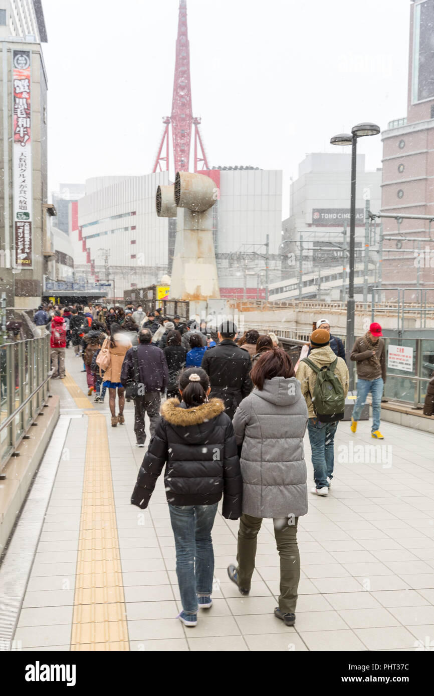 OSAKA, JAPAN - FEB 9: Pedestrians at Osaka Station in Osaka, Japan on February 9, 2015. Osaka Station is a major railway station in the Umeda district Stock Photo