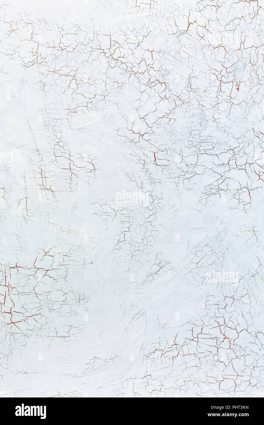 Cracks in the white wall plaster. Stock Photo