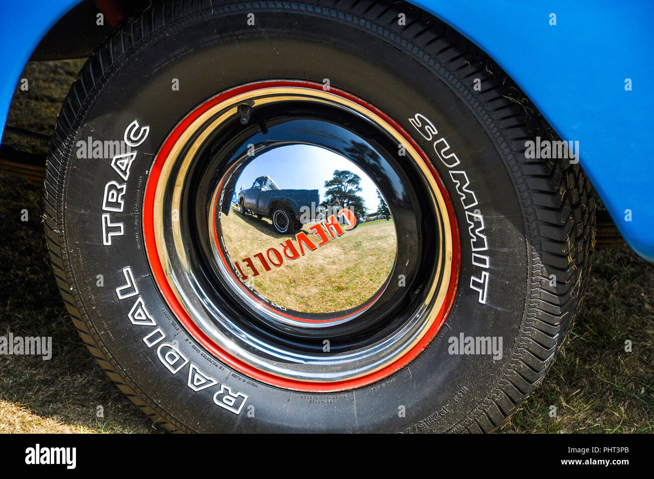 Summit radial trac tyre, tire on a Chevrolet car vehicle with shiny chrome hub cap. Wheel. Truck. Text. Goodwood 2013 Stock Photo