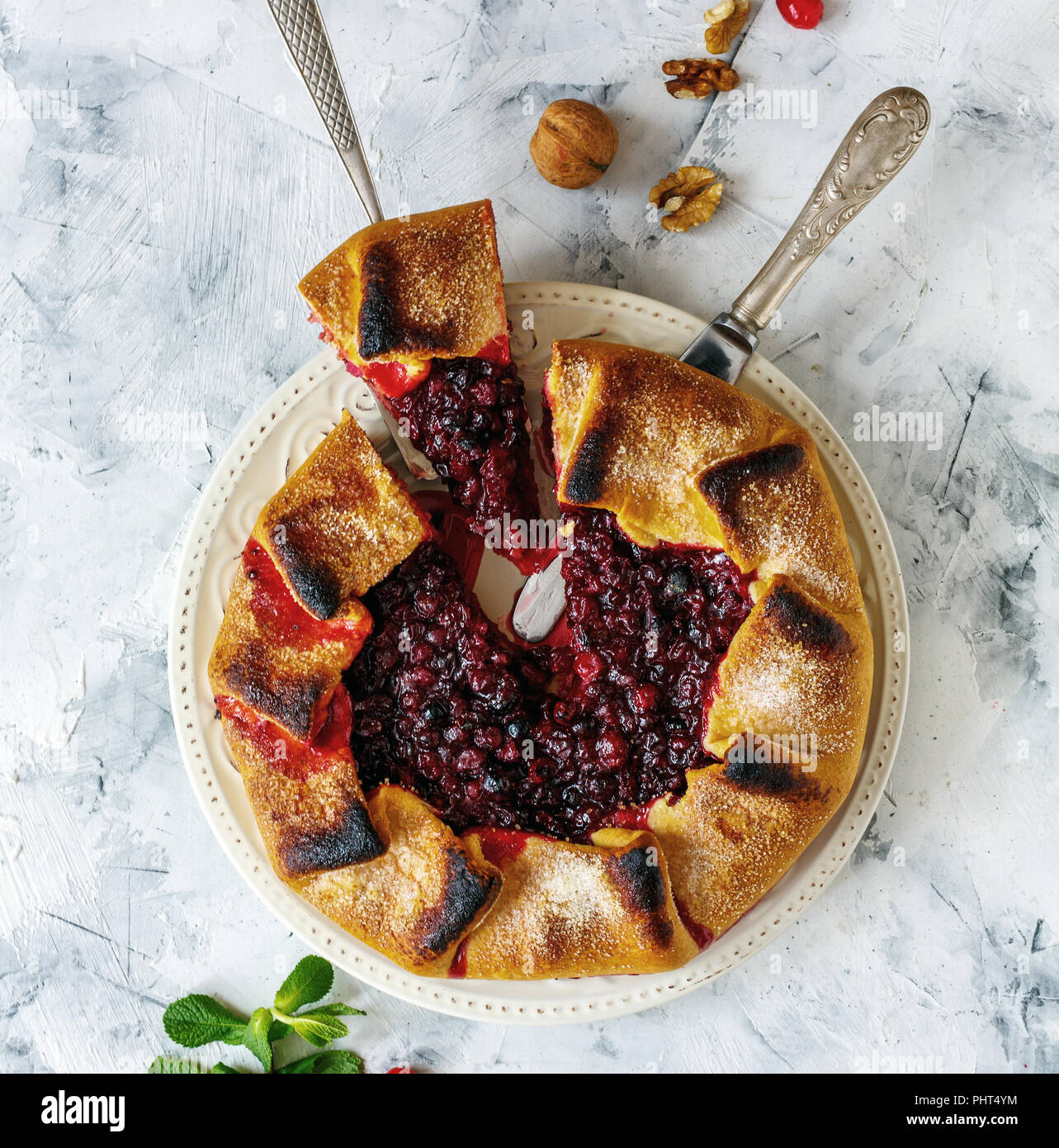 Plate with sliced cranberry free-form pie(galette). Stock Photo