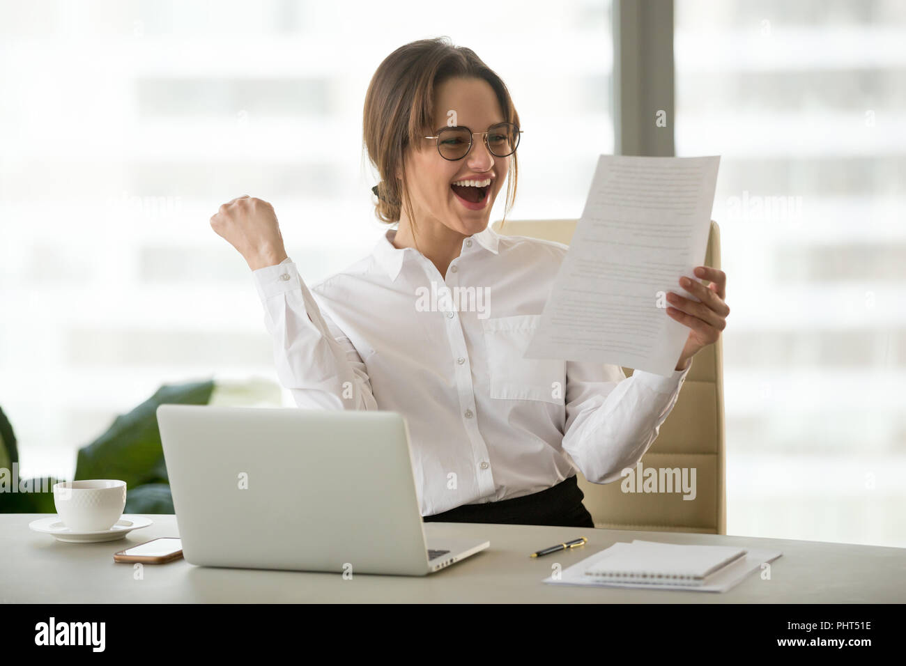 Excited employee reading letter with good news happy about promo Stock Photo