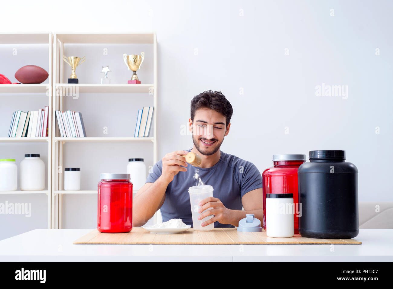 Athlete tasting new protein supplements for better muscles Stock Photo