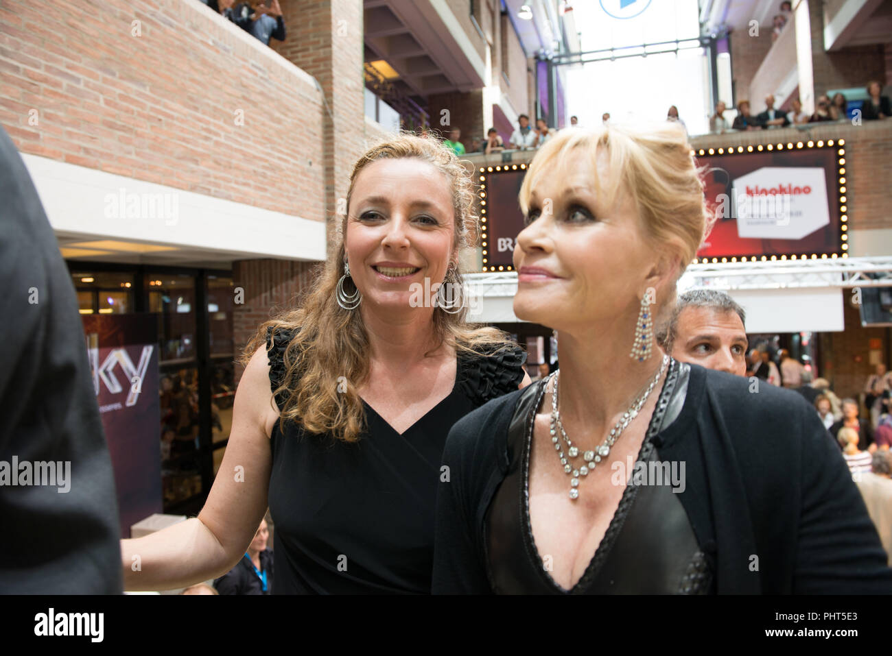Actress Melanie Griffith arrives at Filmfest München 2012 together with Festival Director Diana Iljine Stock Photo