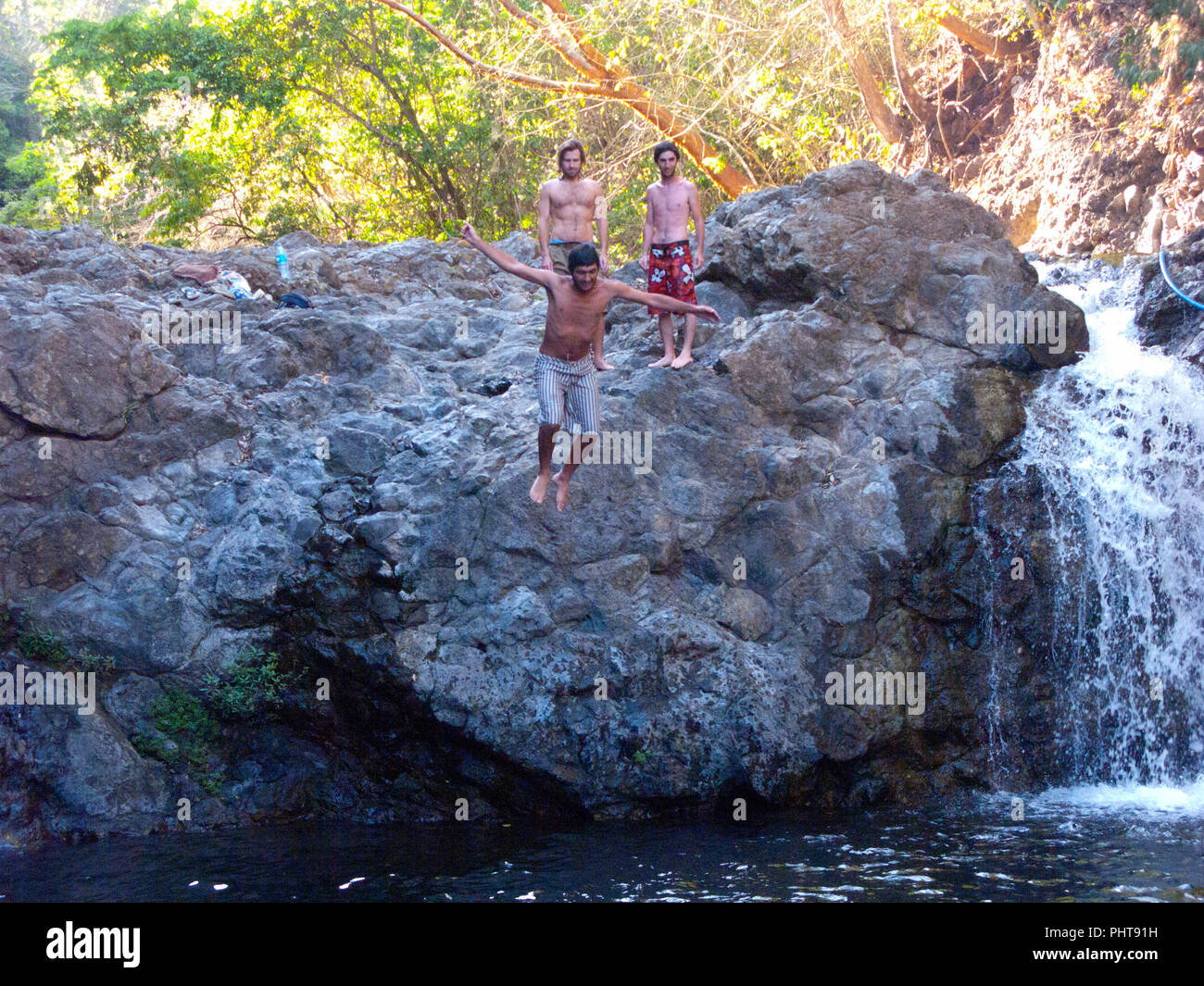 kids jumping at a waterfall in Montezuma,Costa Rica Stock Photo - Alamy