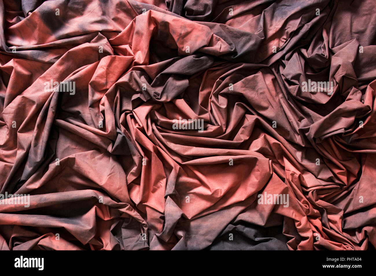 Red Black Cotton Textured Cloth Folded With Deep Shadows Stock Photo