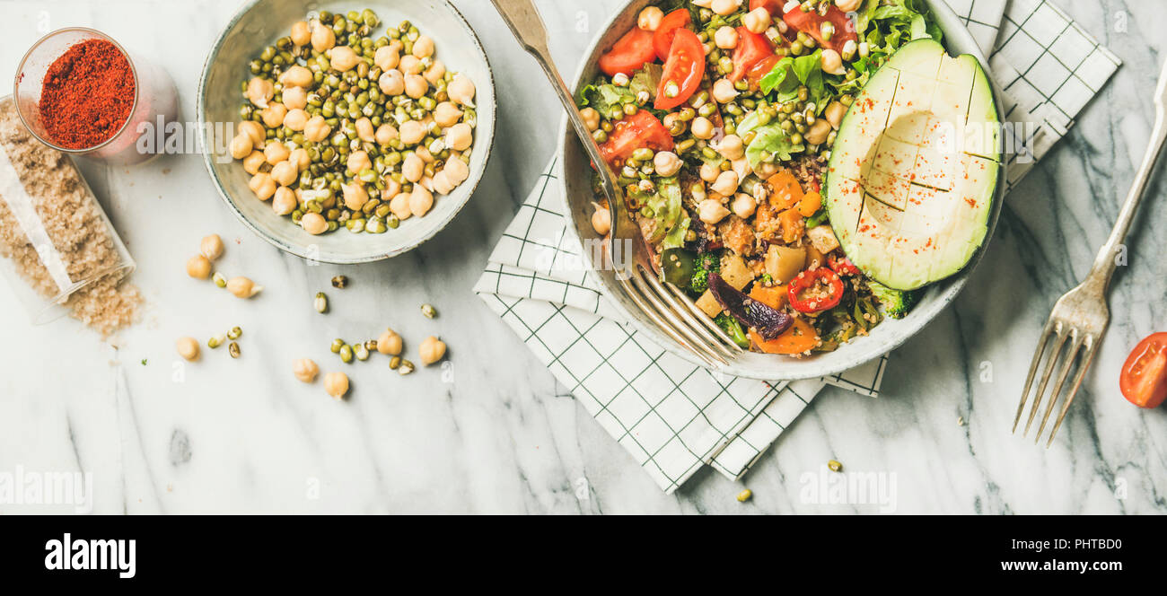 Vegan lunch bowl. Flatlay of dinner with avocado, mixed grains, beans