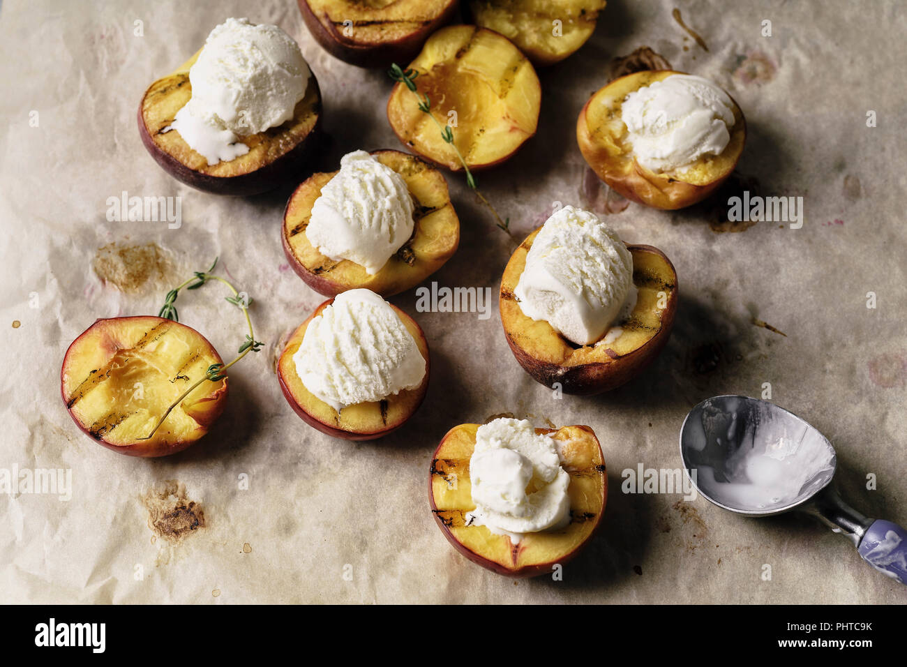Grilled peaches and nectarines served with vanilla ice cream Stock