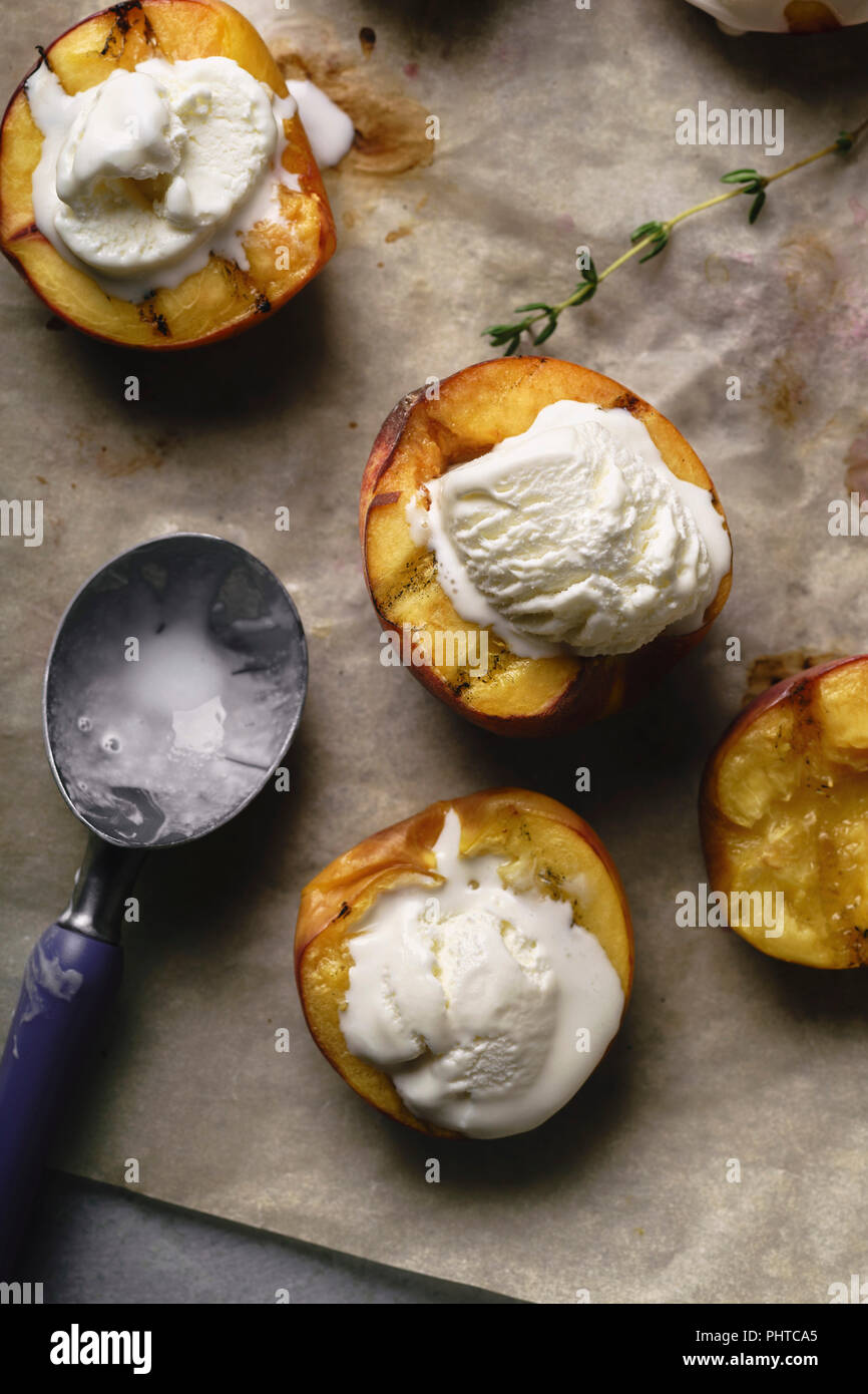 Grilled peaches and nectarines served with vanilla ice cream Stock