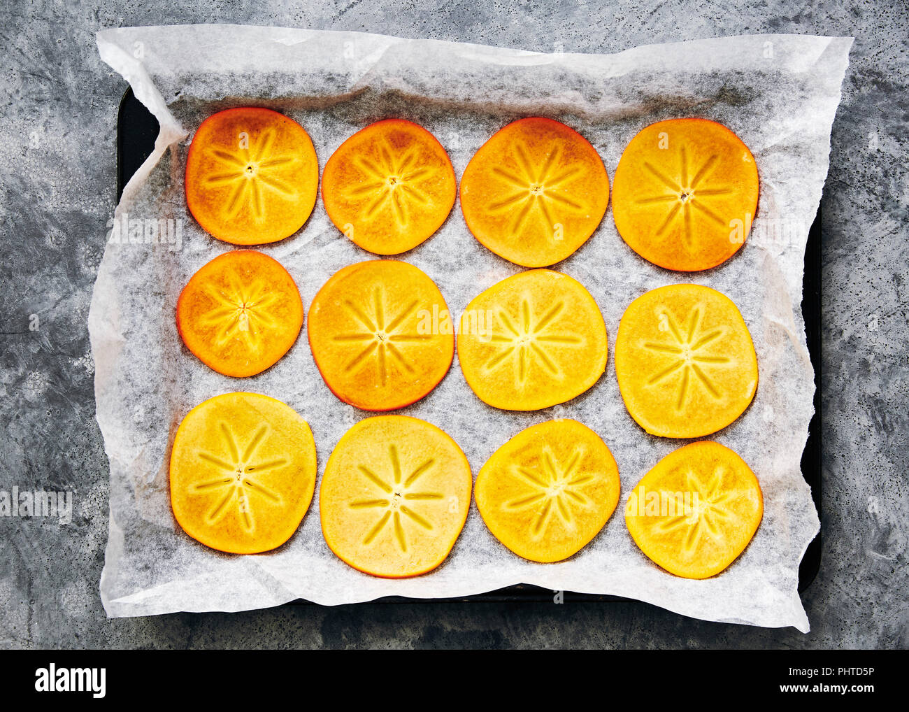 Freshly cut persimmon bake in the oven to make dried persimmon flowers