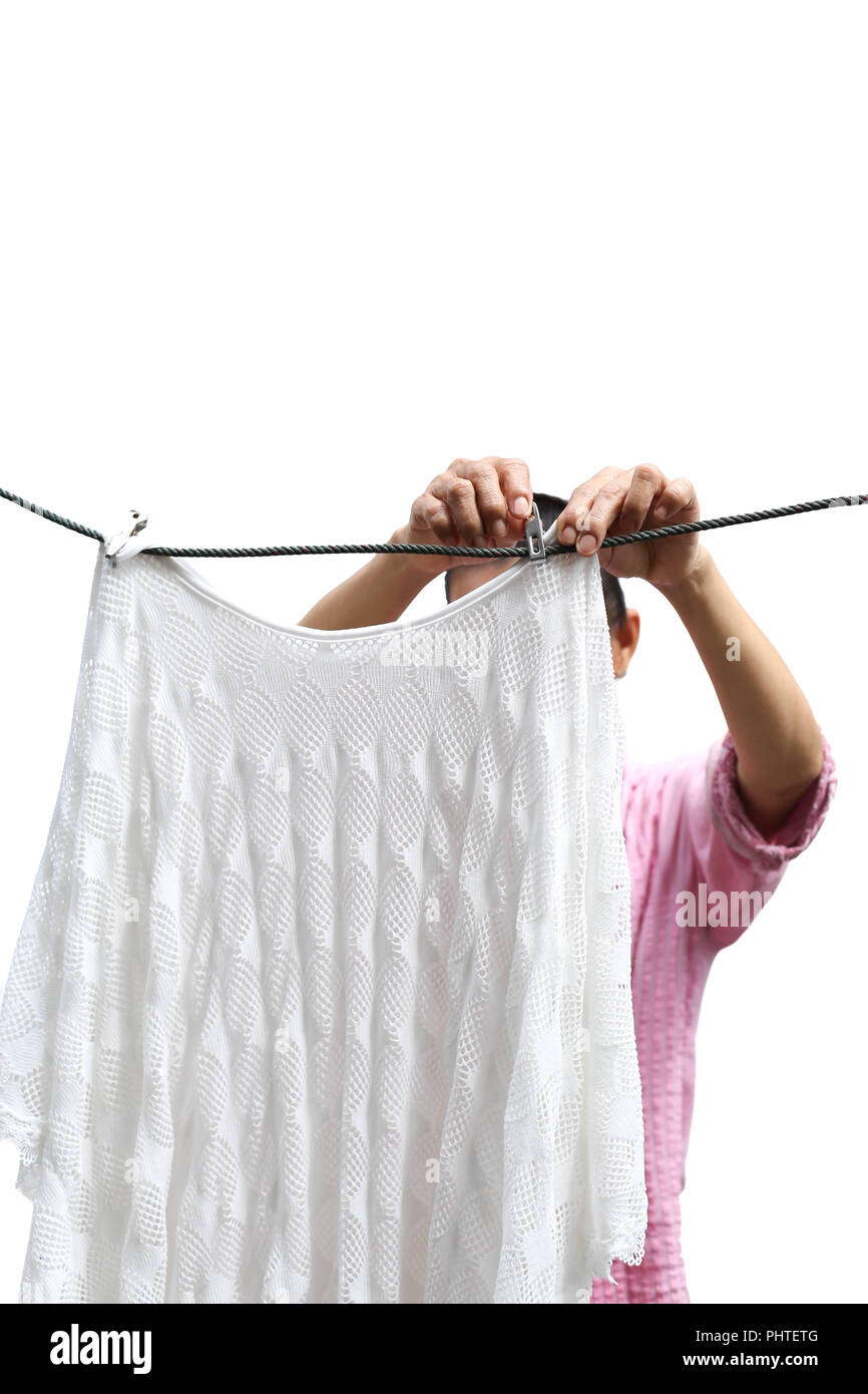 Housework woman hand hanging clean wet laundry to dry clothes is Stock Photo
