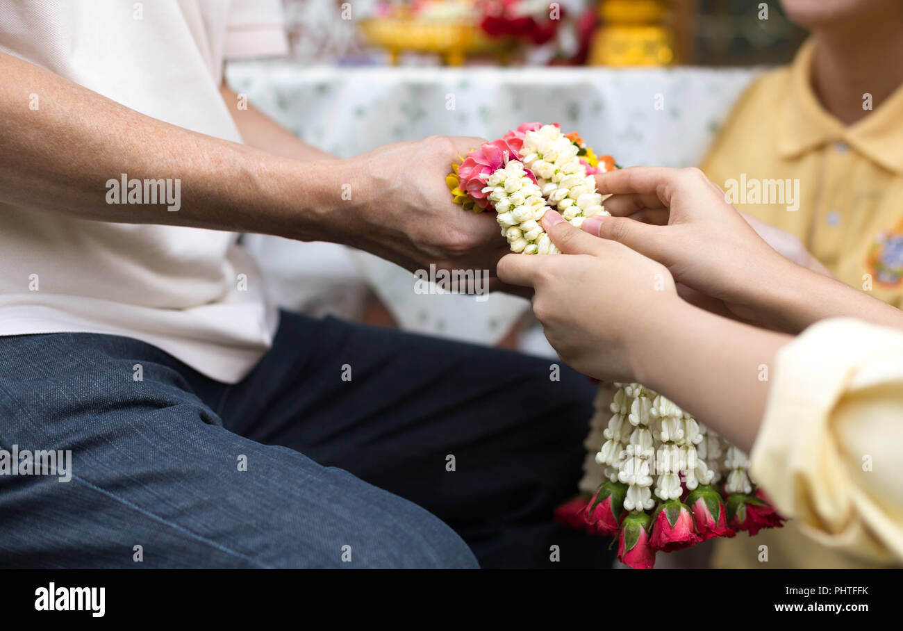 Daughter give jasmine garland to father in fathers day  Stock Photo