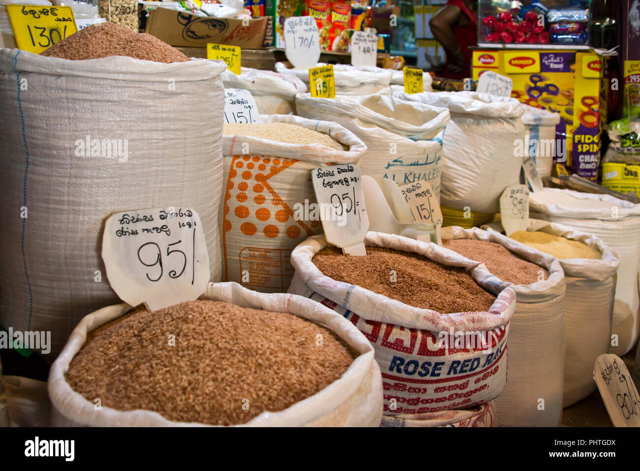 Horizontal close up of sacks full of traditional reed rice for sale in Sri Lanka. Stock Photo