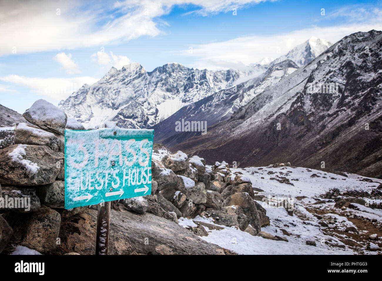 A Guest House sign in Lumde looking down the valley to Kongde Ri.  Sagarmatha National Park, Nepal. Stock Photo
