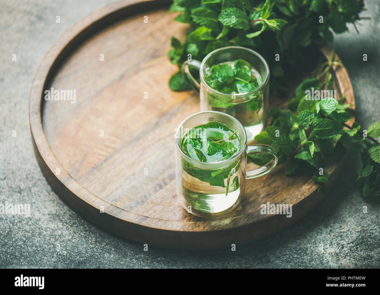 Hot herbal mint tea in glass mugs with leaves Stock Photo