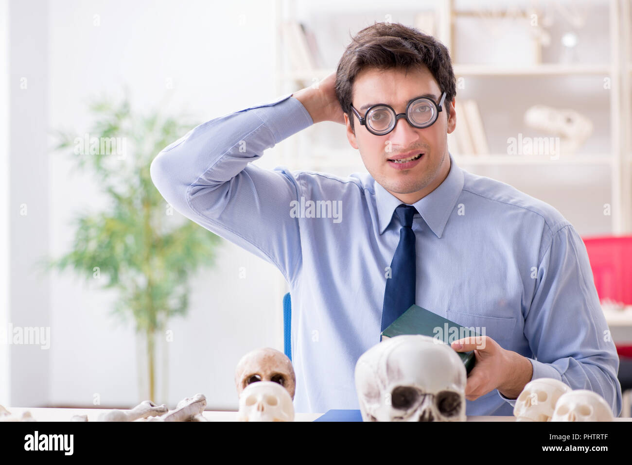 Funny crazy professor studying human skeleton Stock Photo Alamy