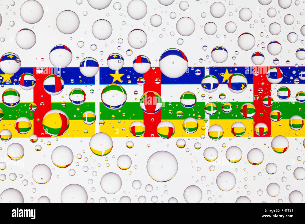 Flags of Central African Republic behind a glass covered with raindrops ...