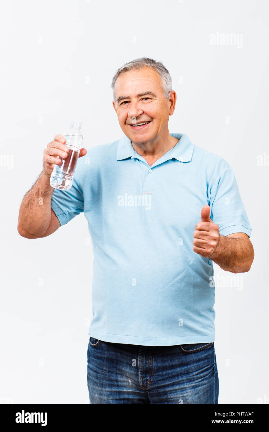 Senior man drinking water and showing thumb up Stock Photo - Alamy