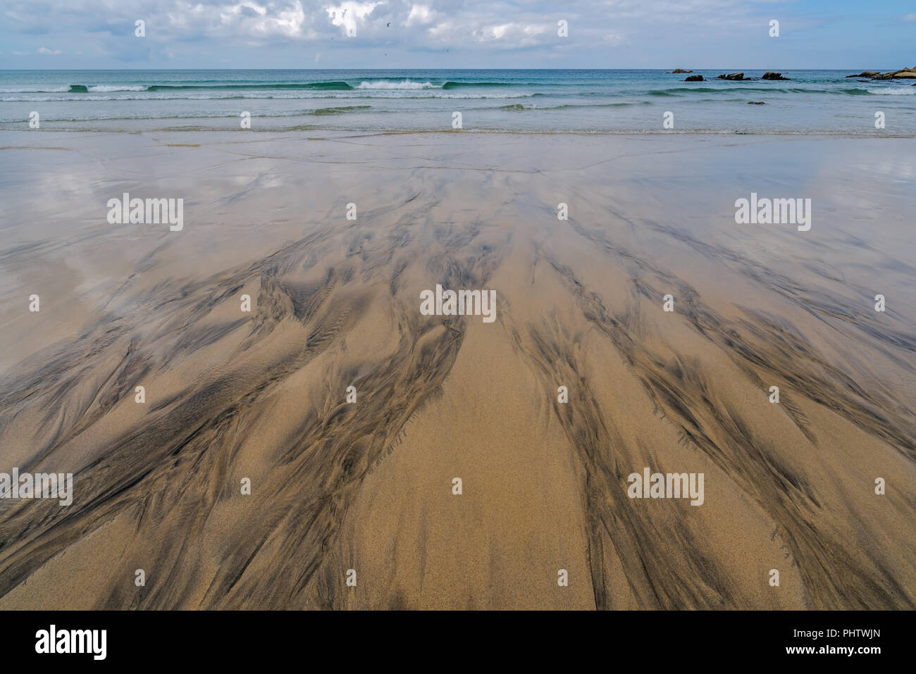 Black patterns on the beach sand Stock Photo