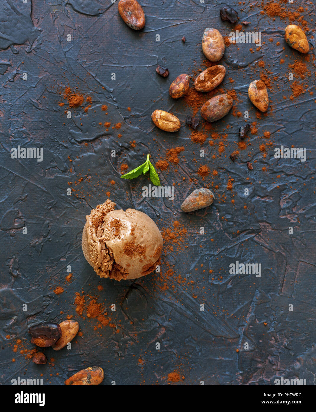 Ball of chocolate ice cream, cocoa beans and powder Stock Photo Alamy