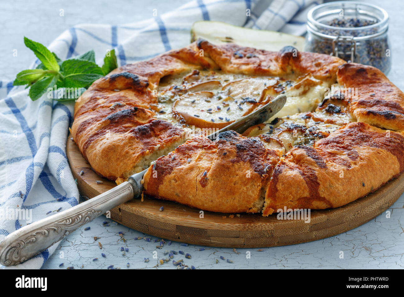 Cut free-form pie (Galette) with pear and lavender. Stock Photo