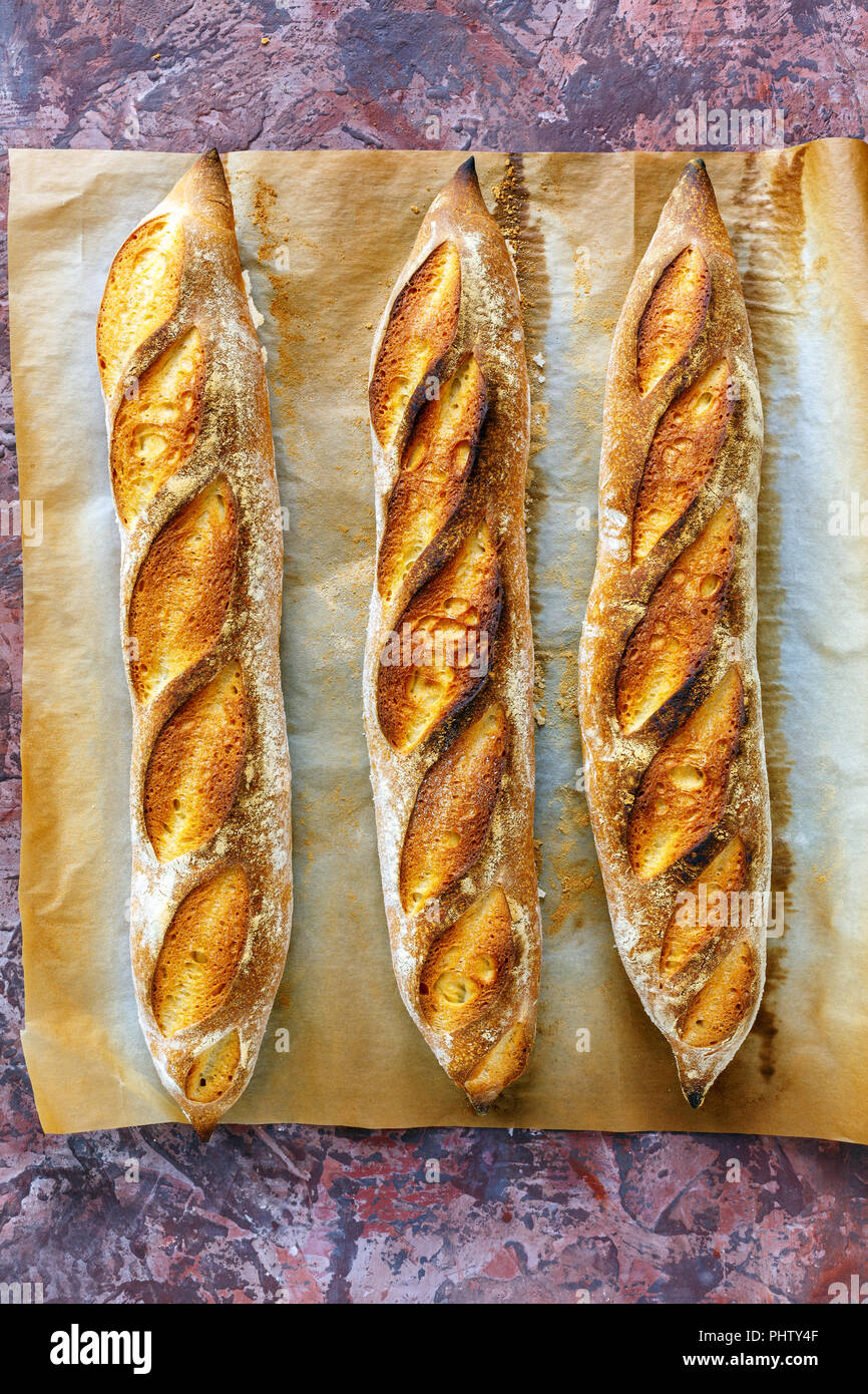 Freshly baked artisanal baguettes. Stock Photo
