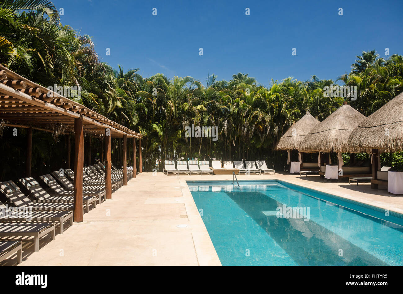 VIP swimming pool area of a mexican caribbean resort Stock Photo - Alamy