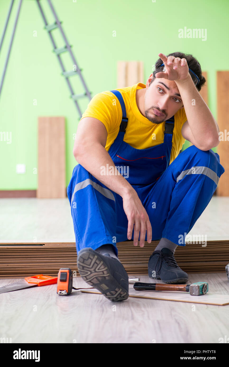 Professional contractor laying flooring at home Stock Photo - Alamy