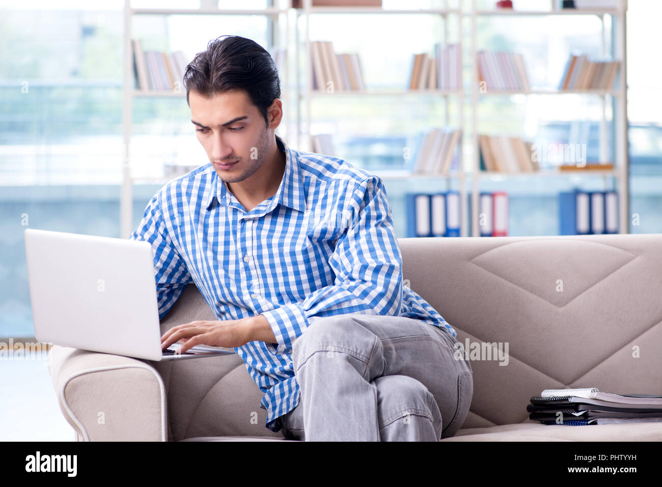 Caucasian student with laptop preparing for university exams Stock