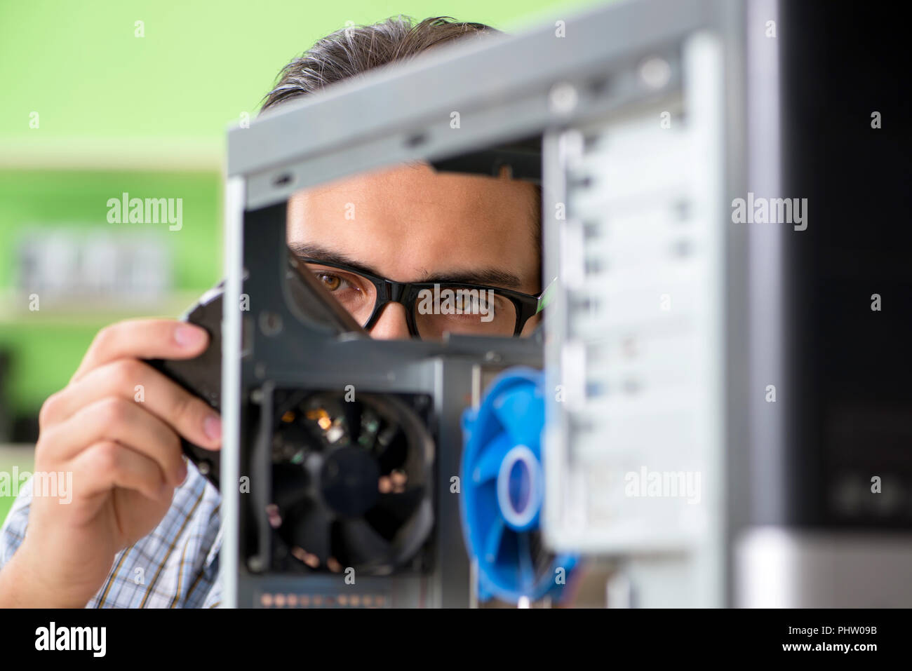 Computer engineer repairing broken desktop Stock Photo