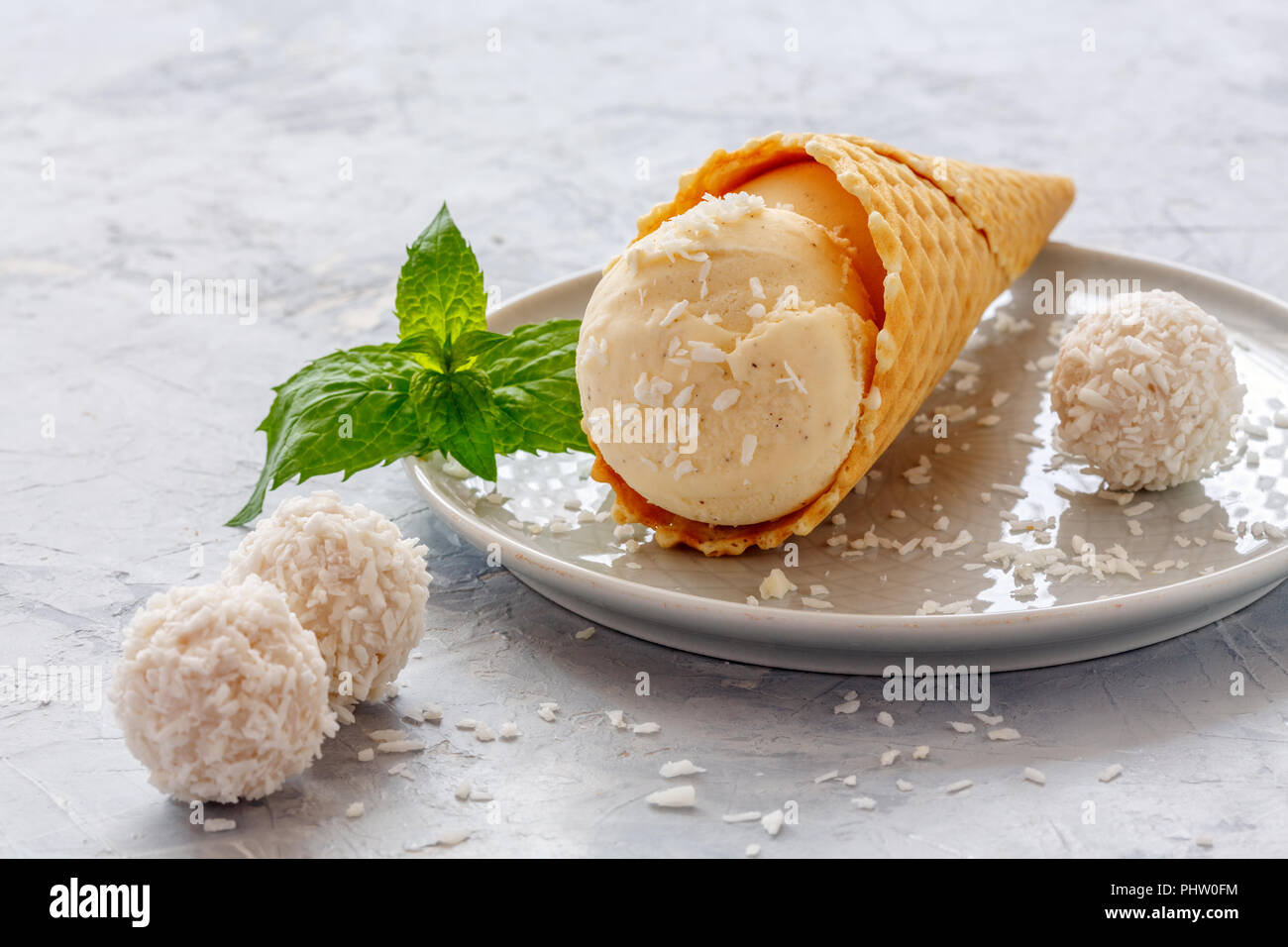 Ball of coconut ice cream in a waffle cone Stock Photo - Alamy