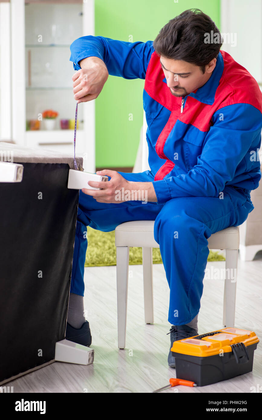Repair contractor repairing broken furniture at home Stock Photo Alamy