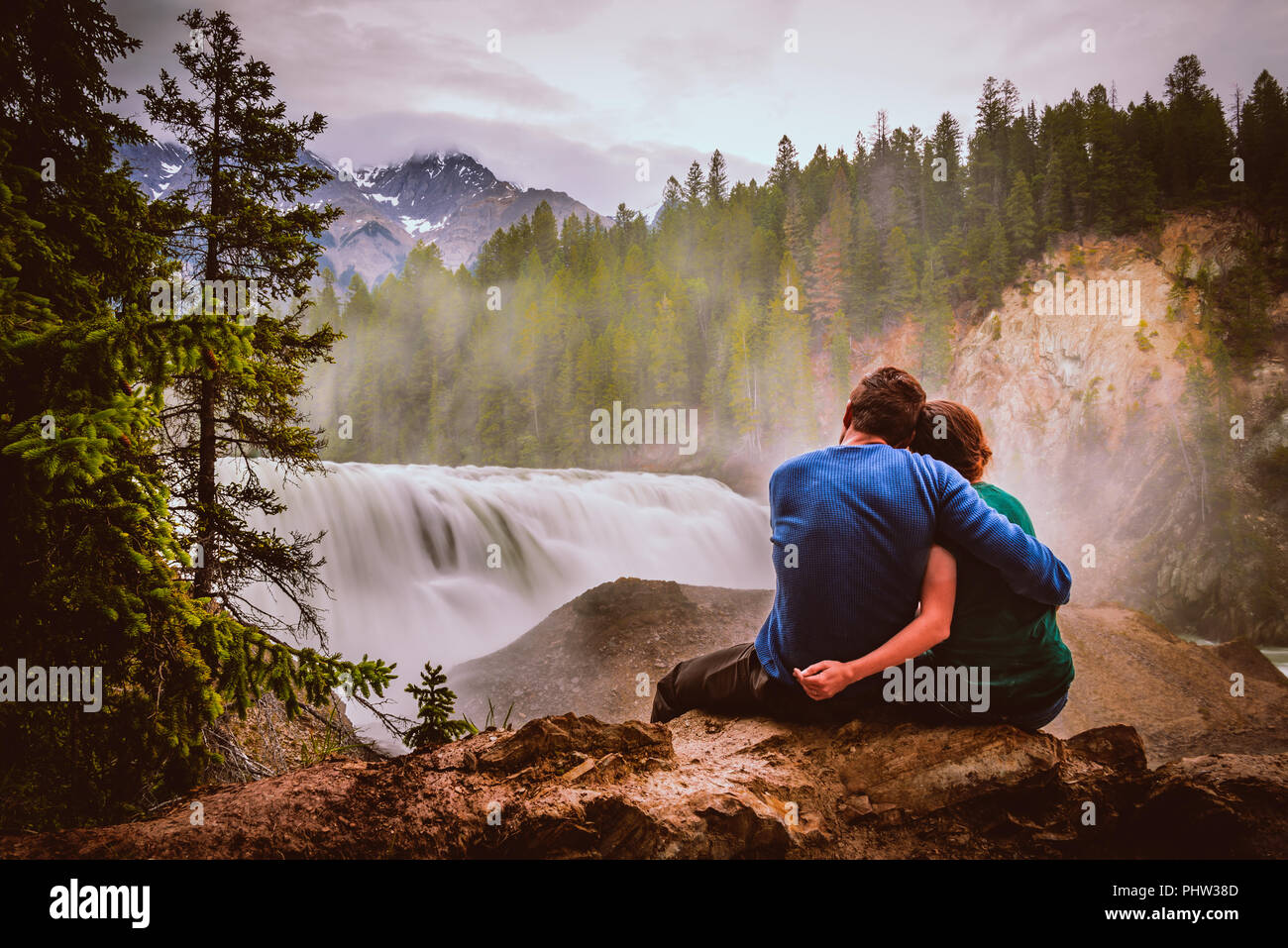 A couple sitting and admiring the view of What falls in Canada, BC Stock Photo