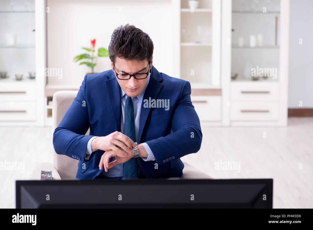 Businessman watching tv in the office Stock Photo