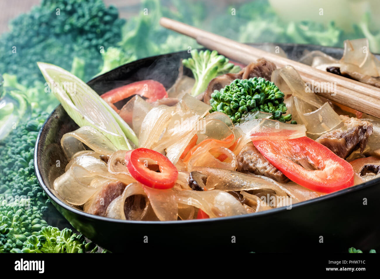 Hot asian spicy dish thick cut glass noodles mung fungosa beans in sweet sour sauce Stock Photo