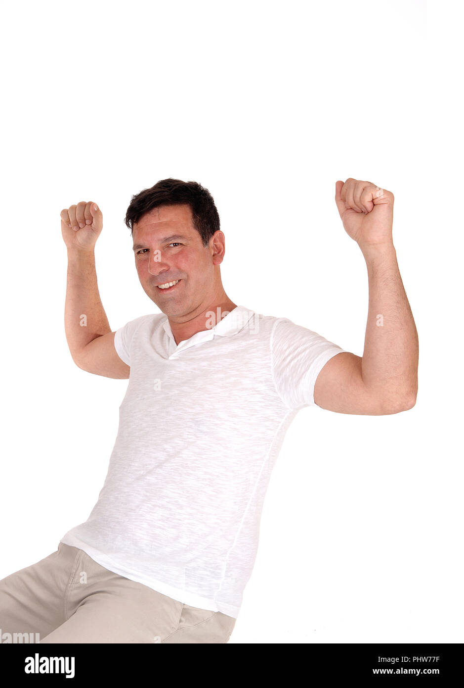 Happy man lifting his fists for excitement Stock Photo