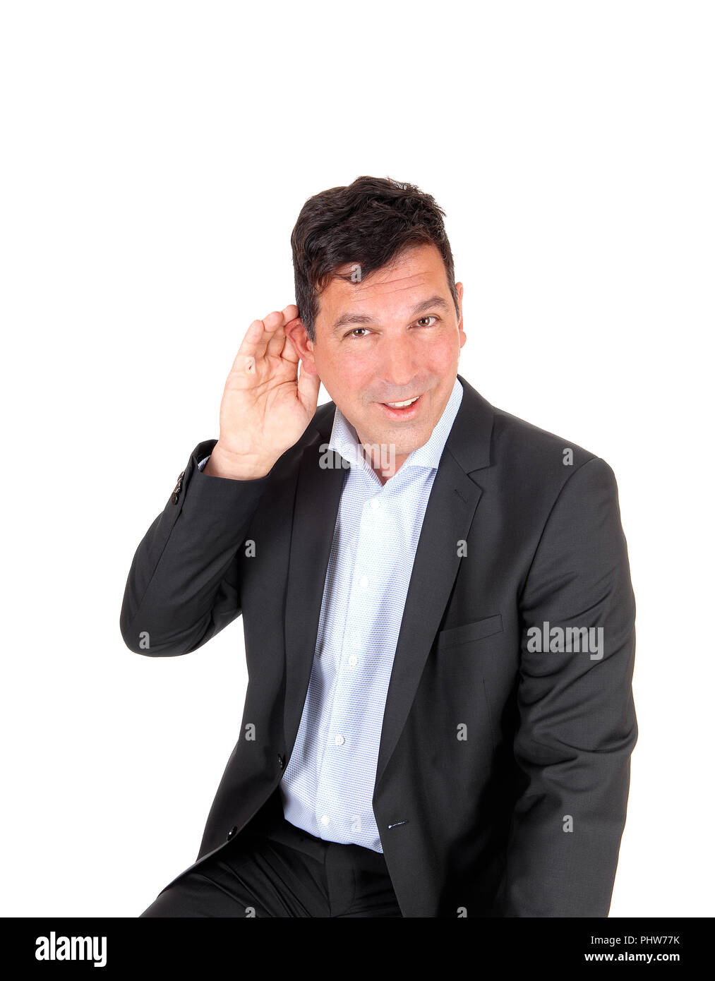Man sitting with hand on ear can not hear Stock Photo