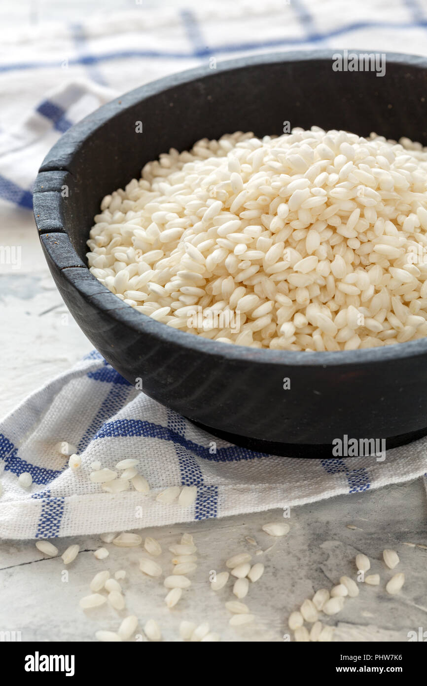 Round white rice in a wooden bowl. Stock Photo
