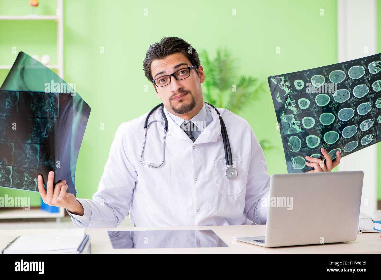 Doctor radiologist looking at x-ray scan in hospital Stock Photo - Alamy
