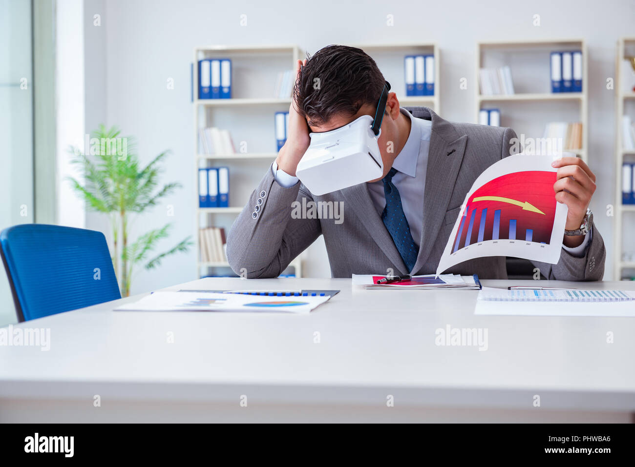 Businessman with virtual reality glasses in the office Stock Photo - Alamy