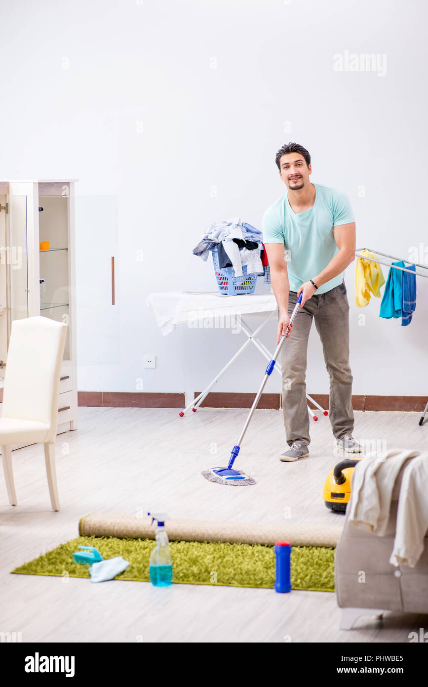 Young attractive man husband doing mopping at home Stock Photo Alamy