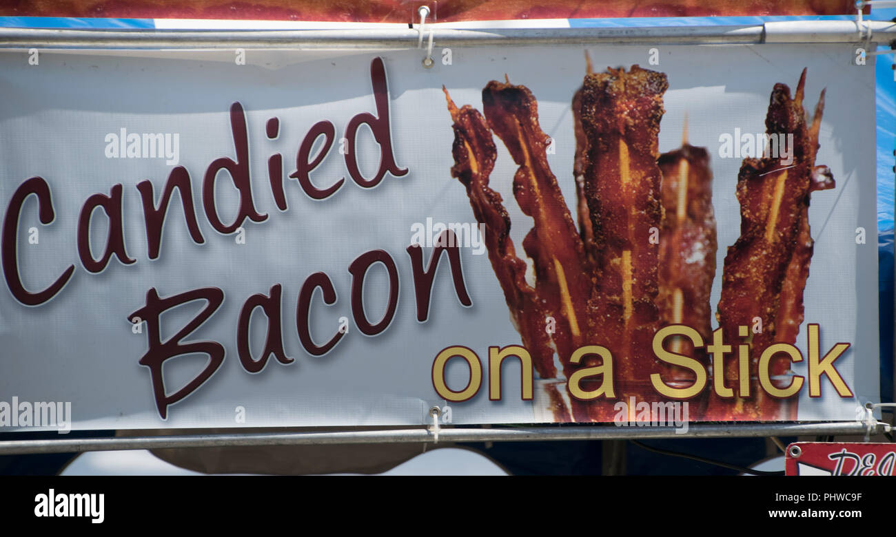 Sign for candied bacon on a stick at the Matthews Alive street fair on Labor Day weekend in Matthews, NC USA Stock Photo