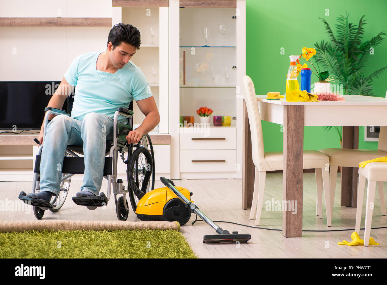 Disabled man on wheelchair vacuum cleaning house Stock Photo Alamy