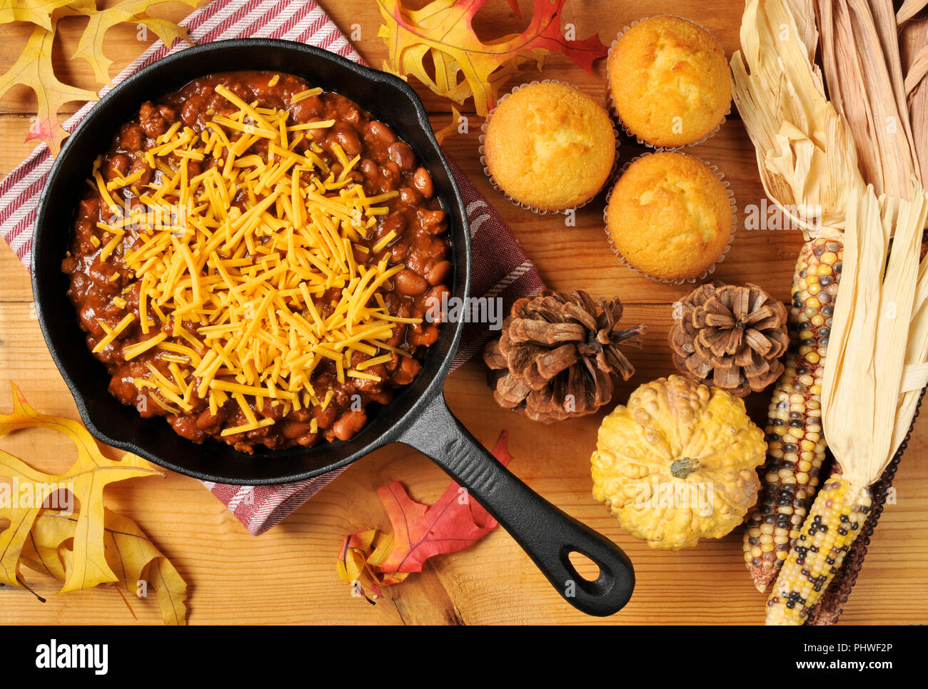 Chili con carne with cheese and corn bread muffins shot from above