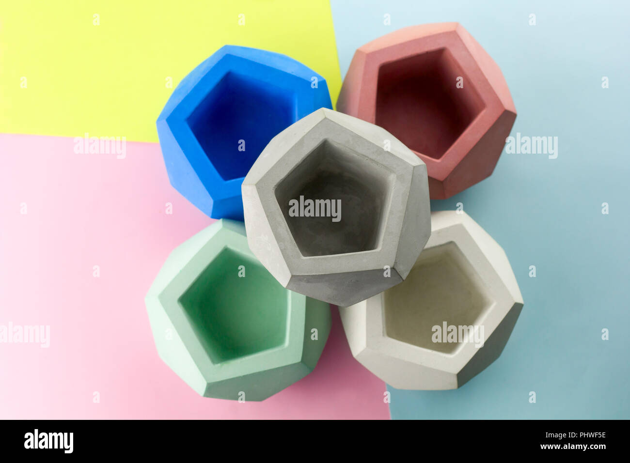 concrete pot for plants ,empty ,polygonal shape,bright background Stock Photo