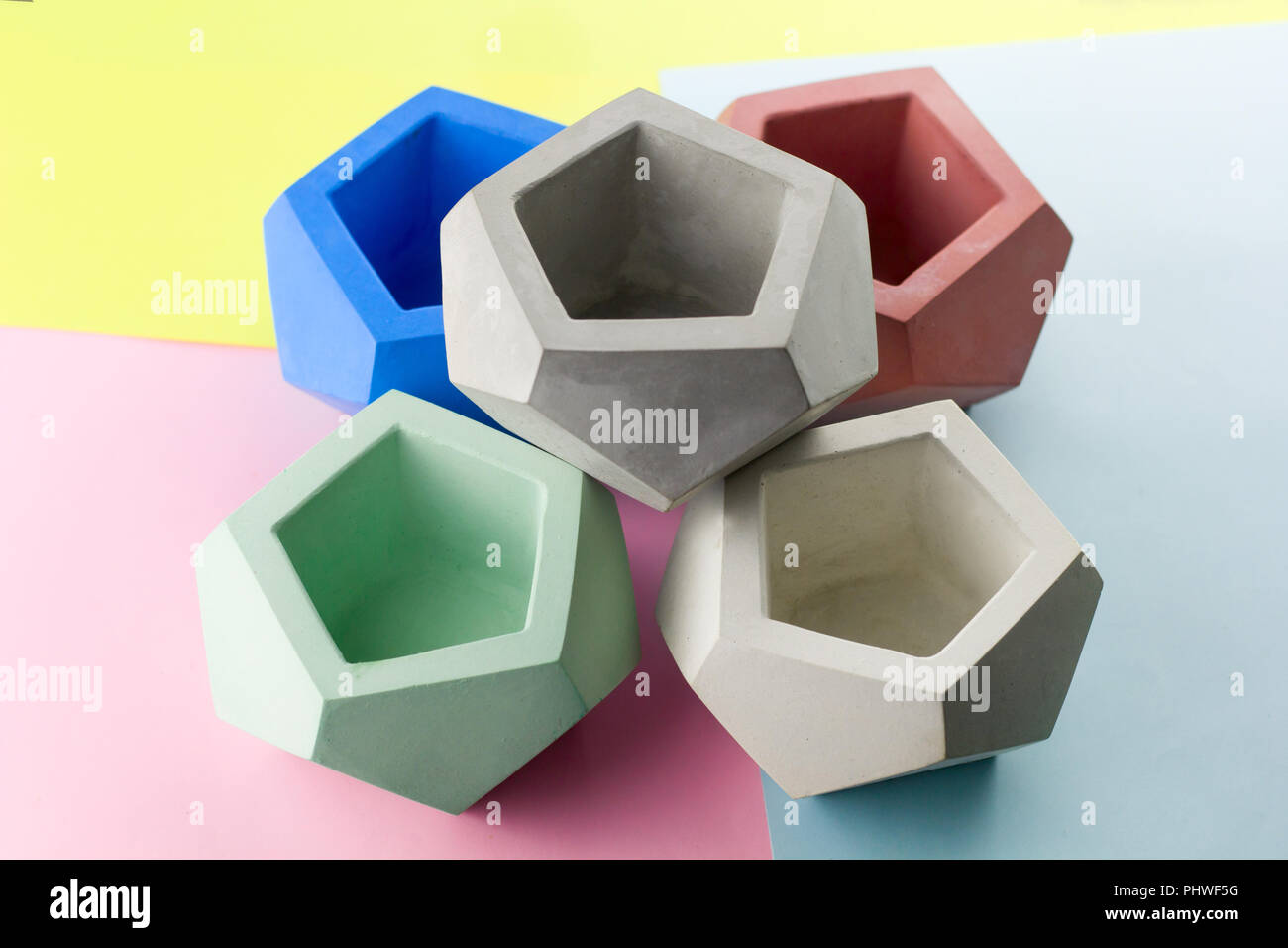 concrete pot for plants ,empty ,polygonal shape,bright background Stock Photo